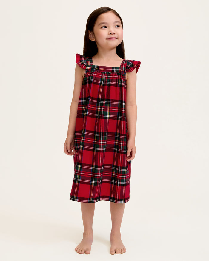 The Girl's Brushed Twill Clara Nightgown in Imperial Tartan is a sleeveless, knee-length nightgown with red, green, and white plaid, ruffled shoulder straps, and a gathered waist, shown against a white background.
