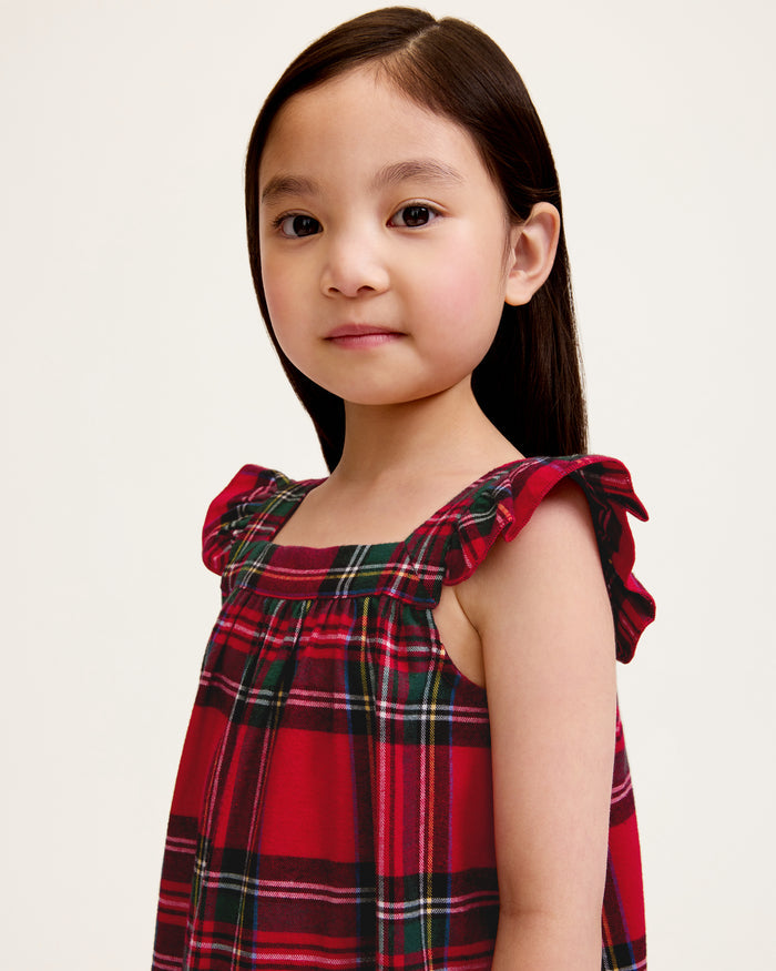 The Girl's Brushed Twill Clara Nightgown in Imperial Tartan is a sleeveless, knee-length nightgown with red, green, and white plaid, ruffled shoulder straps, and a gathered waist, shown against a white background.