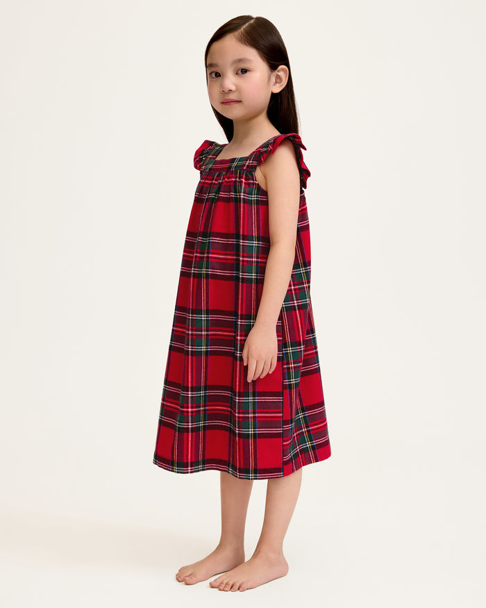 The Girl's Brushed Twill Clara Nightgown in Imperial Tartan is a sleeveless, knee-length nightgown with red, green, and white plaid, ruffled shoulder straps, and a gathered waist, shown against a white background.