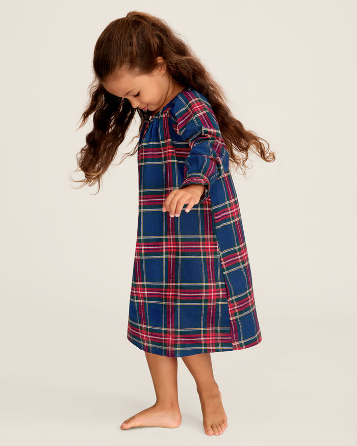 The Girl's Brushed Twill Delphine Nightgown in Windsor Tartan features a blue, green, and red plaid pattern, knee-length long sleeves with ruffled cuffs, and a round neckline with a small button.