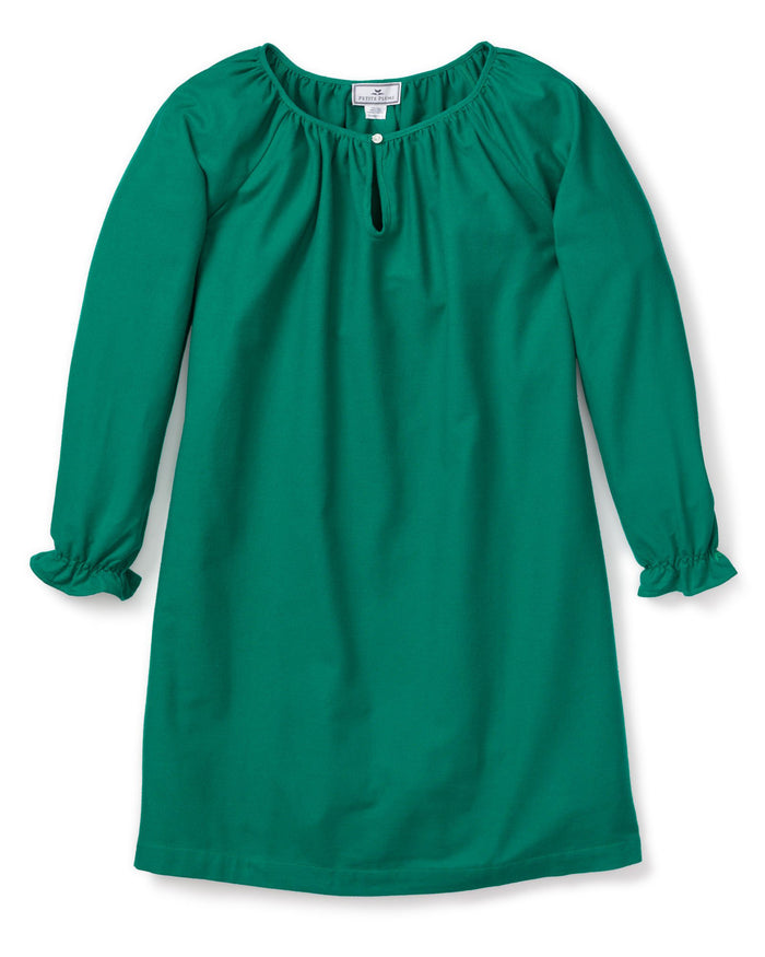 The Girls Flannel Delphine Nightgown in Green by Petite Plume is a soft green flannel gown with a gathered neckline and front keyhole opening. The long sleeves have elastic cuffs for a ruffled effect, and its loose fit ensures comfort. It is displayed flat on a white background.