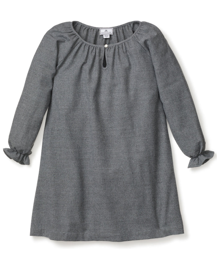 The Girls Flannel Delphine Nightgown in Grey by Petite Plume is a gray, long-sleeved nightgown with a round neckline and front keyhole detail. It features ruffled cuffs and subtly textured brushed cotton flannel, making it perfect for cozy nights as chemical-free sleepwear.