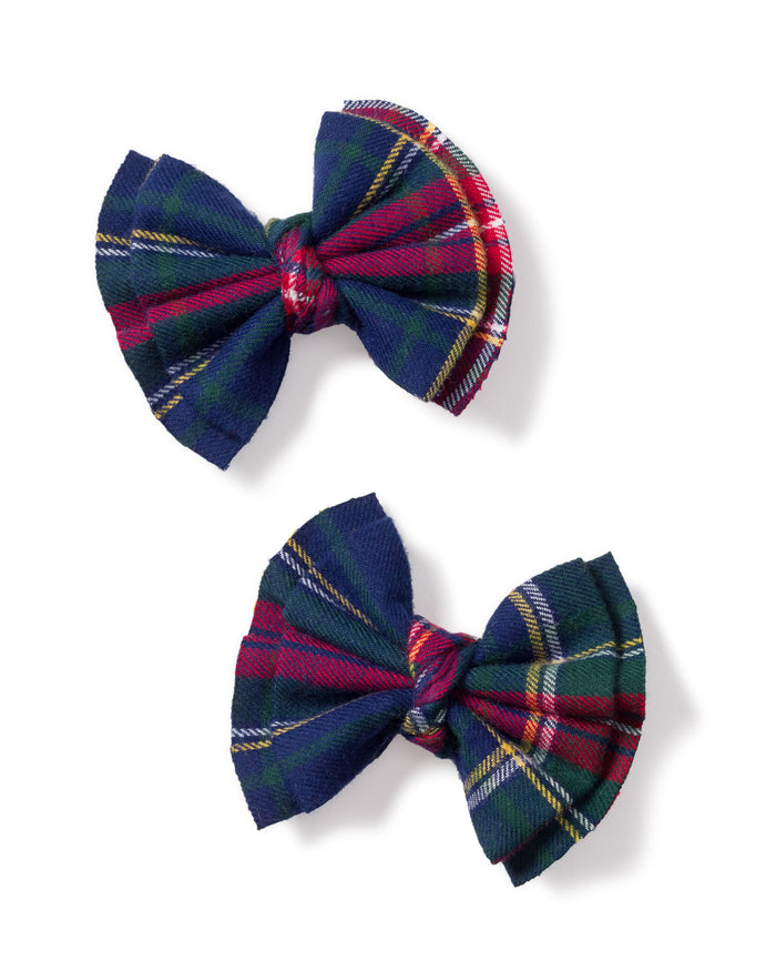 Petite Plumes Girls Hair Bows in Windsor Tartan, a pair in dark blue, red, and green, make ideal stocking stuffers this holiday season. These festive bows add a charming touch against a crisp white background.