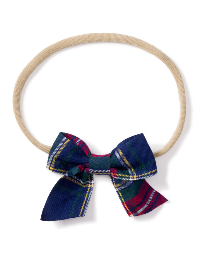 Petite Plumes Girls Hair Bows in Windsor Tartan, featuring a beige elastic headband with a dark blue, green, and red plaid fabric bow, make perfect stocking stuffers or holiday gifts for fans of girls hair bows.