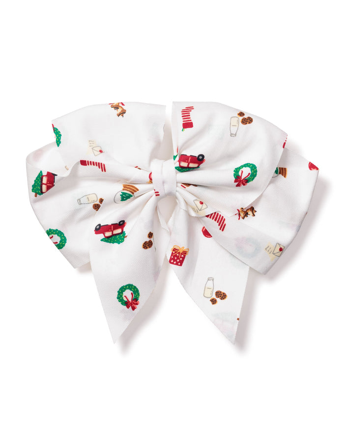 Petite Plumes Girls Hair Bows in Winter Nostalgia features a large white bow with festive patterns like red cars, Christmas wreaths, stockings, and candy canes, making it an ideal holiday gift or stocking stuffer for girls who adore cheerful designs.