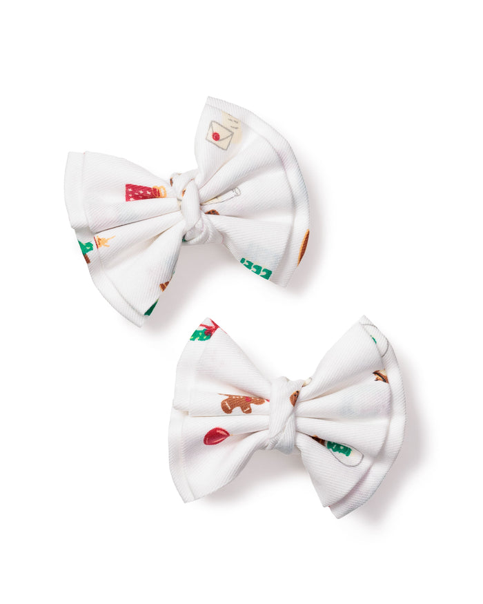 Delightful and festive, Petite Plumes Girls Hair Bows in Winter Nostalgia are crafted with white fabric featuring whimsical heart, mitten, and beverage cup designs. Each bow has a charming center knot and is perfect as a holiday gift or stocking stuffer.