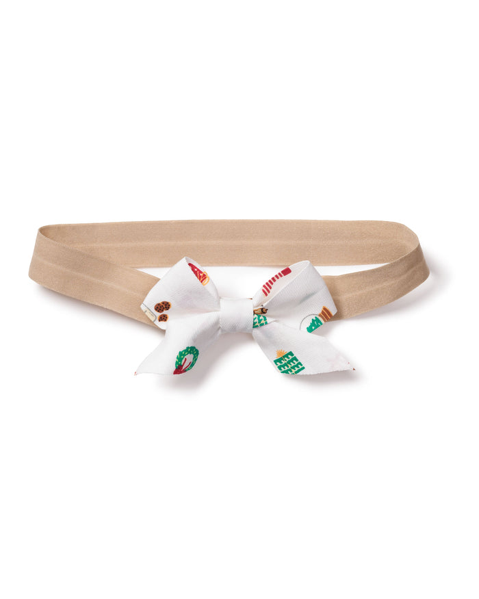 The Petite Plume Girls Hair Bows in Winter Nostalgia make a charming holiday gift with their beige base and playful white bows adorned with green, red, and turquoise patterns. Perfect for stocking stuffers, this delightful accessory is presented flat on a white background.