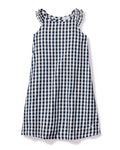 The Girls Twill Amelie Nightgown in Navy Gingham by Petite Plume is a sleeveless cotton dress with a navy and white check pattern. It has a round neck with subtle ruffle detailing for added charm.