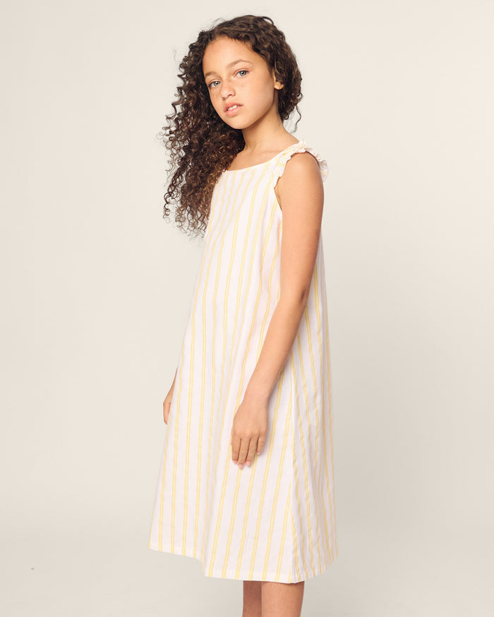 White sleeveless dress with yellow vertical stripes on a white background