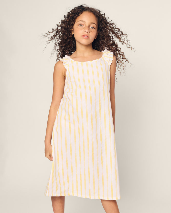 White sleeveless dress with yellow vertical stripes on a white background
