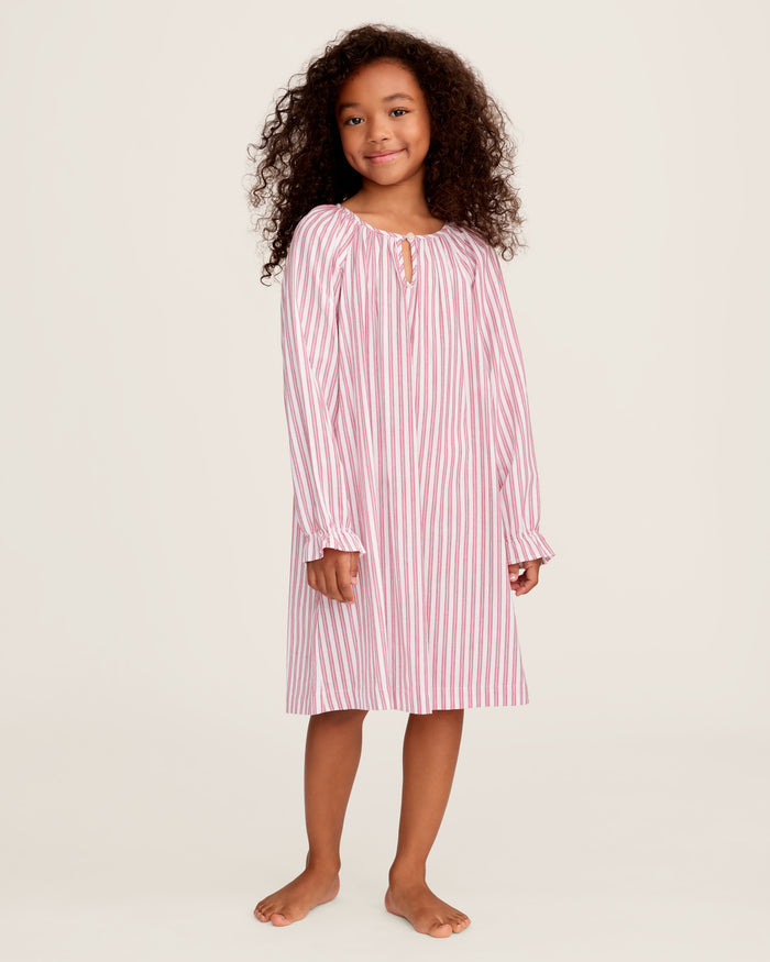 Close-up of Petite Plumes Girls Twill Delphine Nightgown in Antique Red Ticking, featuring pink and white stripes with red stitched ruffles and an embroidered star. Ideal for childrens sleepwear, its smooth texture highlights the detailed pattern and craftsmanship.