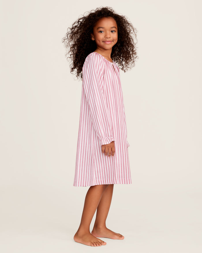 Close-up of Petite Plumes Girls Twill Delphine Nightgown in Antique Red Ticking, featuring pink and white stripes with red stitched ruffles and an embroidered star. Ideal for childrens sleepwear, its smooth texture highlights the detailed pattern and craftsmanship.