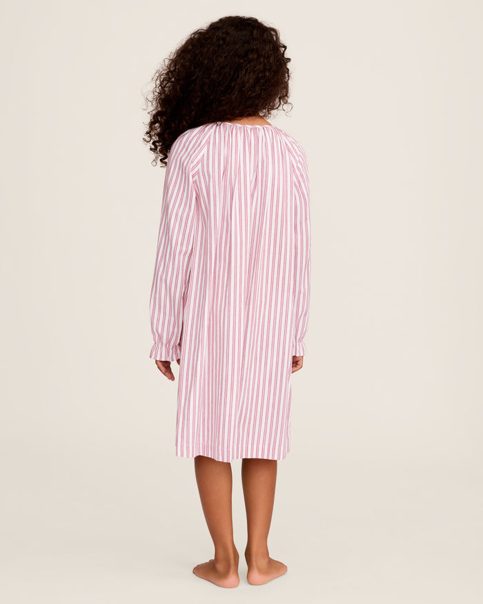 Close-up of Petite Plumes Girls Twill Delphine Nightgown in Antique Red Ticking, featuring pink and white stripes with red stitched ruffles and an embroidered star. Ideal for childrens sleepwear, its smooth texture highlights the detailed pattern and craftsmanship.