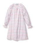 The Girls Twill Delphine Nightgown by Petite Plume in Garnet Tattersall showcases a charming red and white checkered pattern with long sleeves and knee-length. Made from flame-retardant fabric, it features ruffled cuffs and a subtle tie detail at the neckline for safety and style.