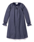 The Girls Twill Delphine Nightgown in Nordic Antlers by Petite Plume features long sleeves, a navy hue with a white scallop design, a round neckline, small front button closure, and gathered cuffs for comfort and style. Crafted from moisture-wicking twill.