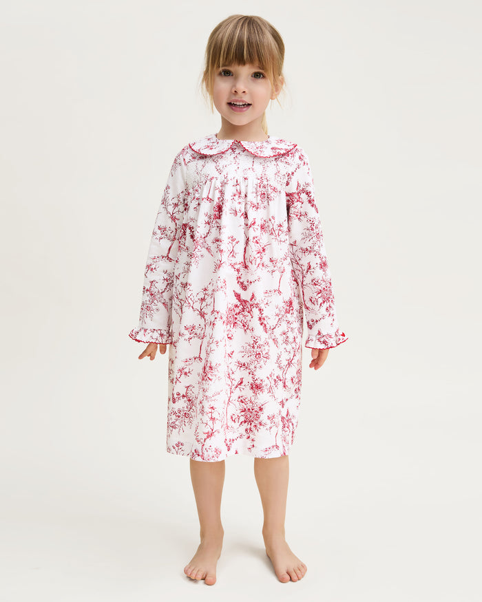 The Girl's Twill Eloise Nightgown in Red Timeless Toile features long sleeves, a white base with red nature-inspired print, gathered yoke, ruffled cuffs, and a scalloped Peter Pan collar.