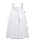 The Girls Twill Esme Nightgown in White by Petite Plume, made from yarn-dyed cotton, boasts a scalloped lace trim on the neckline and straps. Its sleeveless design and lightweight fabric offer a simple yet elegant look with a relaxed fit.