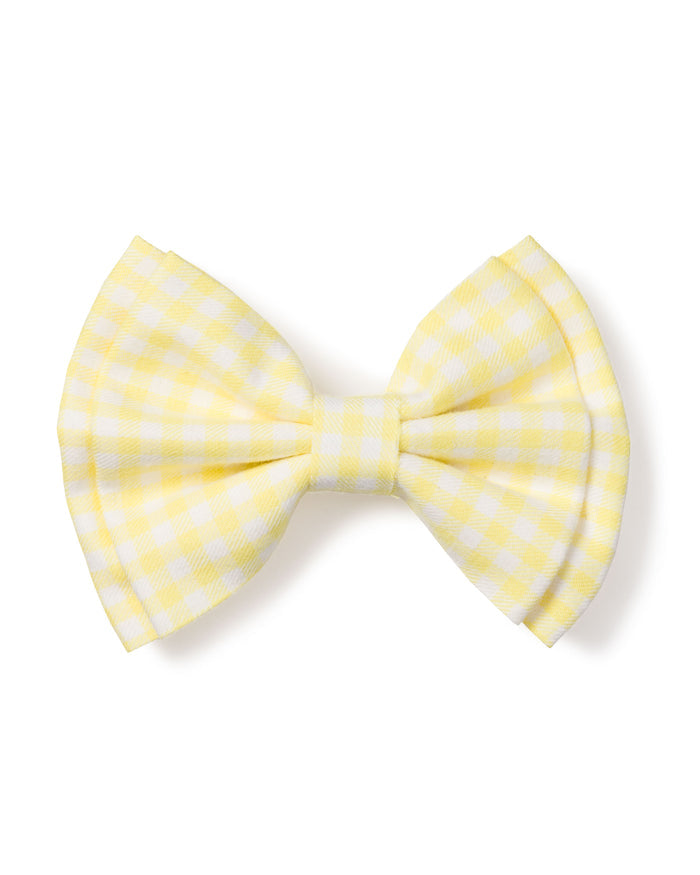 A Petite Plume Girls Twill Hair Bow in yellow gingham, tied with symmetrical loops and tails, is isolated on a white background.