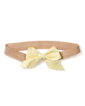 The Petite Plume Girls Twill Hair Bows in Yellow Gingham feature a charming beige elastic headband with a yellow and white checkered bow, complete with two tails. Perfect for complementing pajamas and shown on a plain white background.