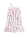Enjoy the elegance of Petite Plumes Girls Twill Lily Nightgown in Seashell Splendor—a white sleeveless dress boasting pink and purple floral and fruit patterns, yarn-dyed cotton, a lacy trim top, and a ruffled hem for luxurious sleep.