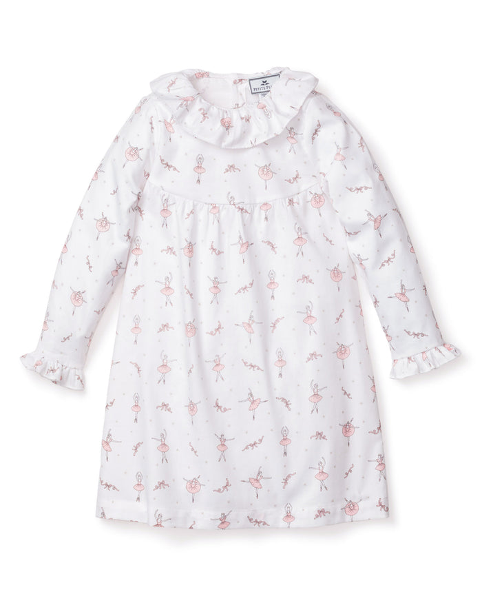 The Petite Plume Girls Twill Scarlett Nightgown in Sugar Plum Fairy features a charming pattern with pink ballerinas, ruffled cuffs, and collar. Crafted from flame-retardant fabric, its A-line silhouette ensures comfort and safety for any young dreamer.
