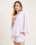 The Olivia Pima Short Set in Pink Stripe features a two-piece pajama set with white and pink vertical stripes, a long-sleeve button-up top with chest pocket, and matching drawstring shorts.