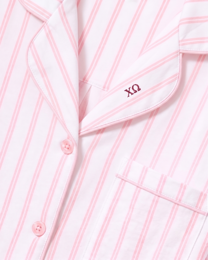 Close-up of the Greek Embroidered Women’s Pima Pajama Set in Pink Stripe, featuring pink buttons, a pocket, and embroidery of the Greek letters ΧΩ above the pocket.