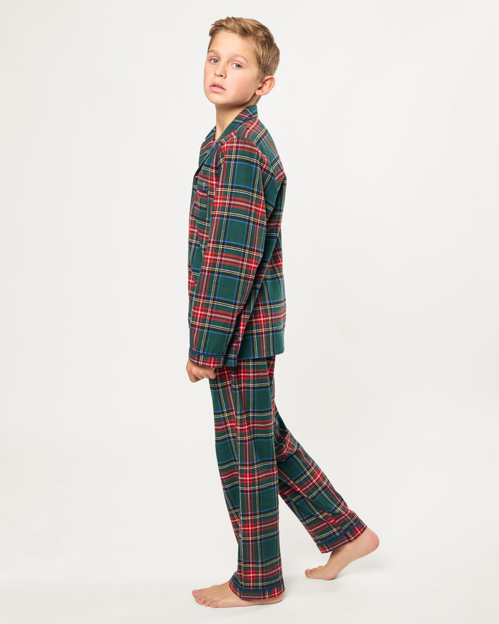 The Kid's Brushed Twill Pajama Set in Kensington Tartan, featuring a green, red, and yellow plaid button-up top with a chest pocket and matching long pants, is shown laid flat on a white background.