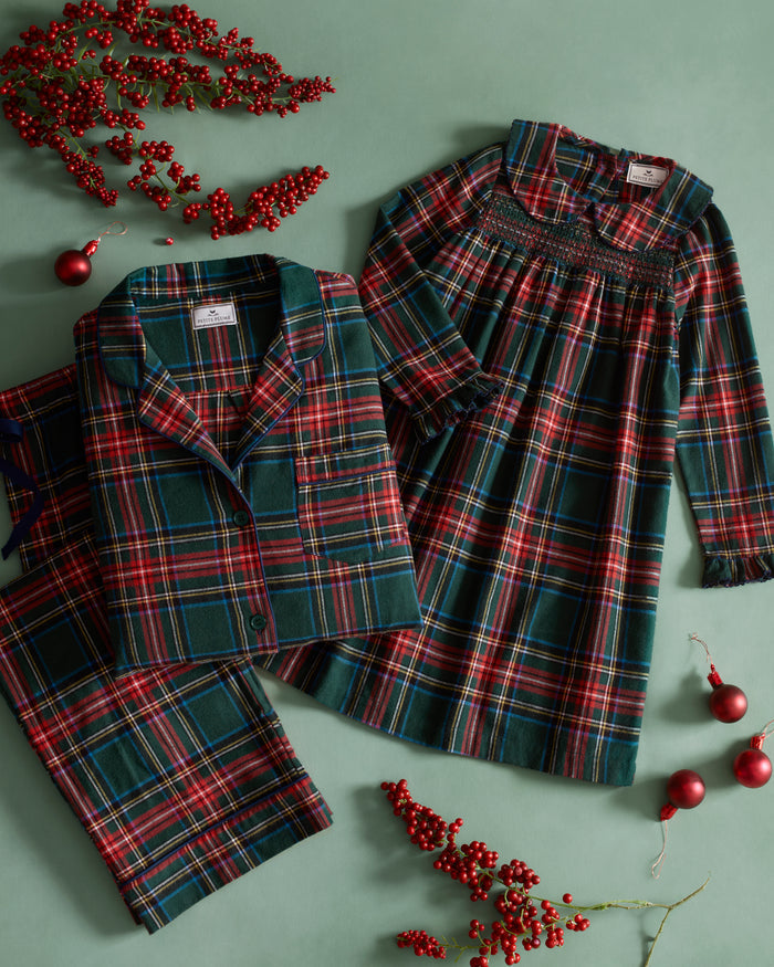 The Kid's Brushed Twill Pajama Set in Kensington Tartan, featuring a green, red, and yellow plaid button-up top with a chest pocket and matching long pants, is shown laid flat on a white background.