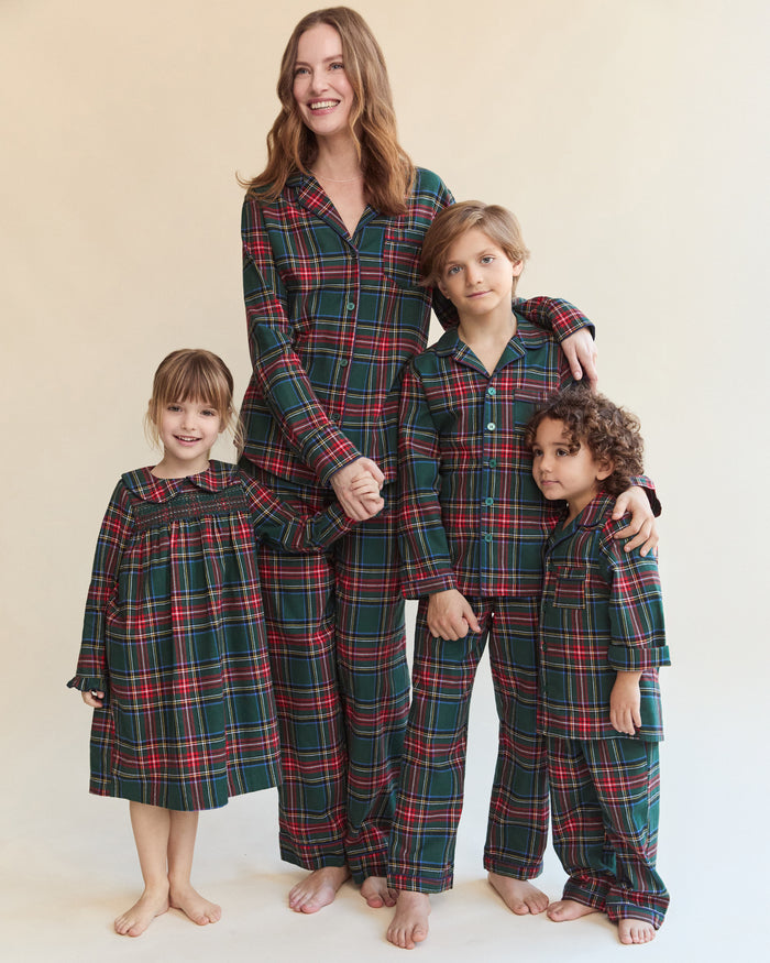 The Kid's Brushed Twill Pajama Set in Kensington Tartan, featuring a green, red, and yellow plaid button-up top with a chest pocket and matching long pants, is shown laid flat on a white background.