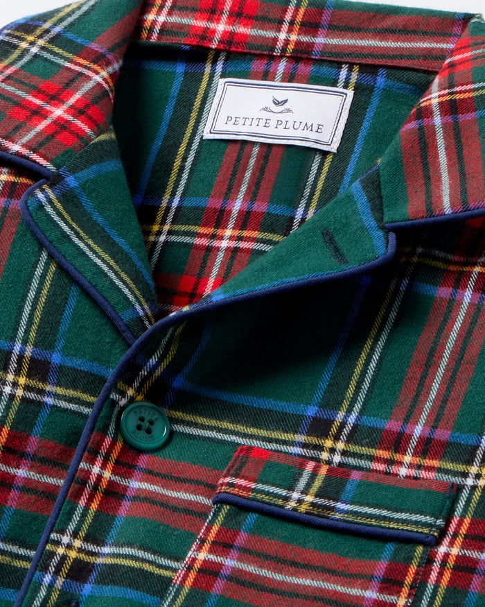 The Kid's Brushed Twill Pajama Set in Kensington Tartan, featuring a green, red, and yellow plaid button-up top with a chest pocket and matching long pants, is shown laid flat on a white background.