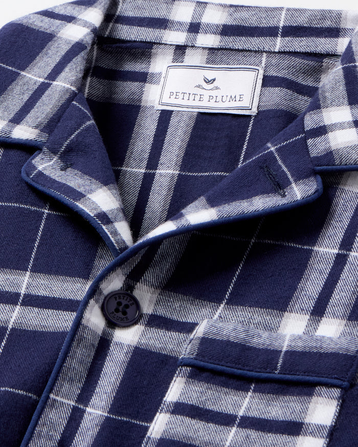 Kid's Brushed Twill Pajama Set in Oxford Tartan, featuring a navy and white plaid long-sleeve button-up top with chest pocket and matching elastic-waist pants, displayed neatly on a white background.