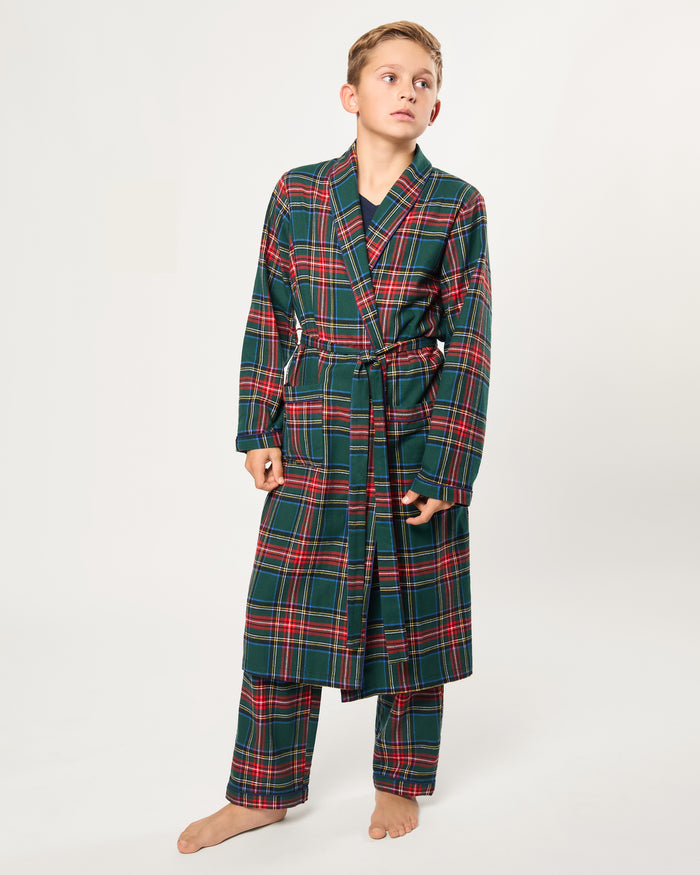The Kid's Brushed Twill Robe in Kensington Tartan is knee-length with long sleeves, a shawl collar, two front pockets, and a matching belt. It features a classic green, red, and yellow tartan plaid pattern.