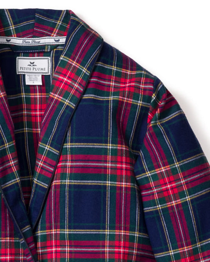 A close-up of the Kid’s Brushed Twill Robe in Windsor Tartan showcases its red, green, and navy blue plaid pattern. The label reads Petite Plume. The material looks soft and the collar is neatly folded.