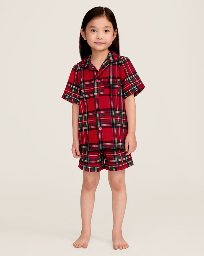 The Kid's Brushed Twill Short Set in Imperial Tartan features red plaid with green, black, and white stripes, including a short-sleeve button-up shirt with a chest pocket and matching elastic waistband shorts.