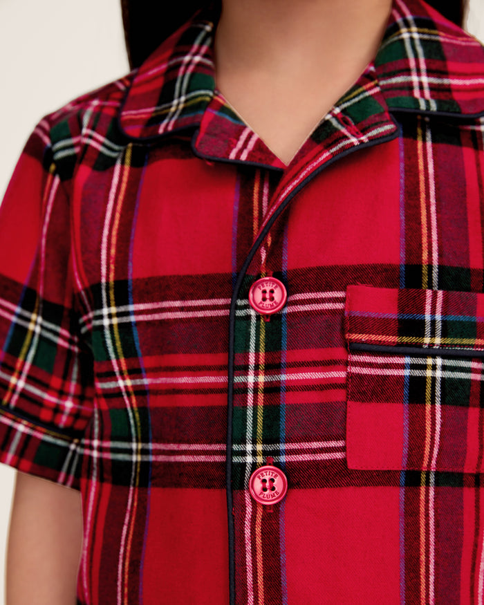The Kid's Brushed Twill Short Set in Imperial Tartan features red plaid with green, black, and white stripes, including a short-sleeve button-up shirt with a chest pocket and matching elastic waistband shorts.