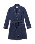 The Kids Flannel Robe in Navy with White Piping by Petite Plume is perfect for childrens sleepwear. It features a belt at the waist, two front pockets, long sleeves, and is made from flame-retardant material for added safety.
