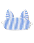 The Kids Kitty Sleep Mask in French Blue Seersucker by Petite Plume features cat-like ears and elastic straps for a snug fit. This playful mask can be monogrammed, making it an ideal gift. Consider matching masks for friends to share the cozy charm.