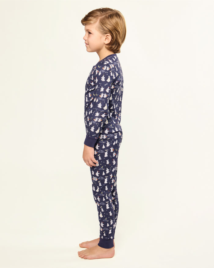 The Kid's Pima Snug Fit Pajama Set in Spooky Slumber is a navy blue pajama set with long sleeves and pants, featuring white and red cartoon dogs in winter gear, plus dark blue cuffs and button details on the top.