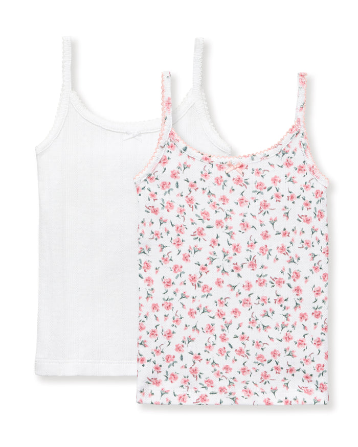 The Kid's Pointelle Cami Set of 2 in White & Pink Floral includes two sleeveless camisoles: one plain white with a bow and one white with a pink and green floral pattern. Both feature thin straps and lace trim.