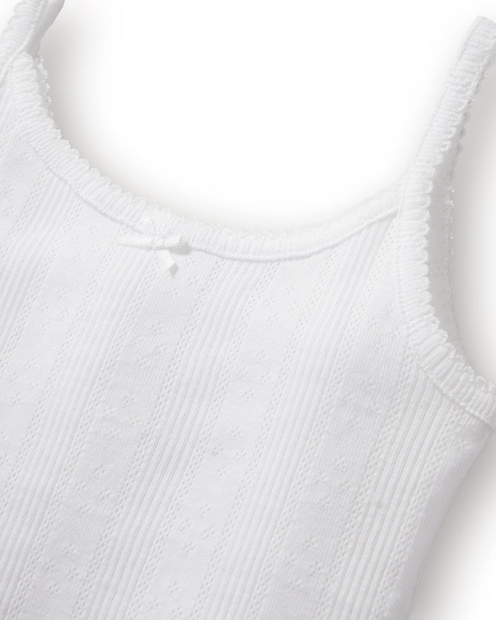The Kid's Pointelle Cami Set of 2 in White & Pink Floral includes two sleeveless camisoles: one plain white with a bow and one white with a pink and green floral pattern. Both feature thin straps and lace trim.