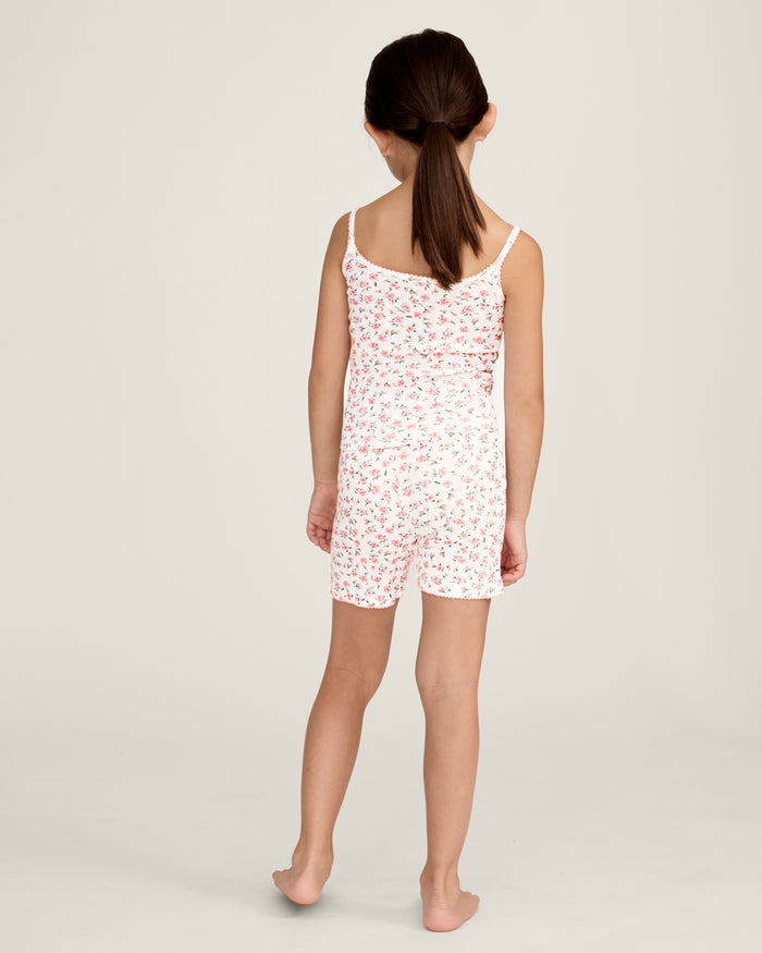 The Kid's Pointelle Cami Set of 2 in White & Pink Floral includes two sleeveless camisoles: one plain white with a bow and one white with a pink and green floral pattern. Both feature thin straps and lace trim.