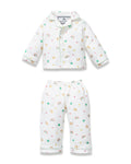 Kid's Twill Doll Pajamas in Good Luck Charms: a white two-piece set with a collared button-up top and matching pants, featuring colorful rainbows, horseshoes, clovers, and stars.