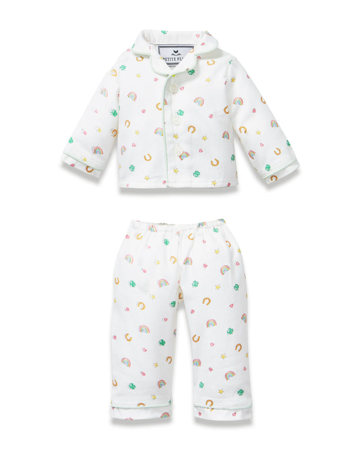 Kid's Twill Doll Pajamas in Good Luck Charms: a white two-piece set with a collared button-up top and matching pants, featuring colorful rainbows, horseshoes, clovers, and stars.
