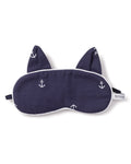 The Kids Twill Kitty Sleep Mask in Portsmouth Anchors by Petite Plume adds luxury to your sleepwear collection with its navy blue color, white anchor patterns, and cat ear shapes. A subtle PETITE monogram on the tag and a black elastic strap complete the design for comfort.
