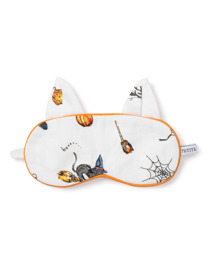 The Kids Twill Kitty Sleep Mask in Trick or Treat by Petite Plume features Halloween icons like a cat, broomstick, pumpkin, spider web, and boo. With white fabric and orange trim, plus fabric cat ears, this mask adds festive charm to your sleepwear.