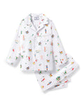 The Kid's Twill Pajama Set in 12 Days of Christmas features a white, long-sleeve button-up top with collar and front pocket, plus matching pants, all adorned with playful, colorful holiday illustrations of people and animals.