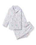 The Kid's Twill Pajama Set in Baking Spirits Bright features white long-sleeve button-up top and long pants with a colorful print of various small household and travel items.