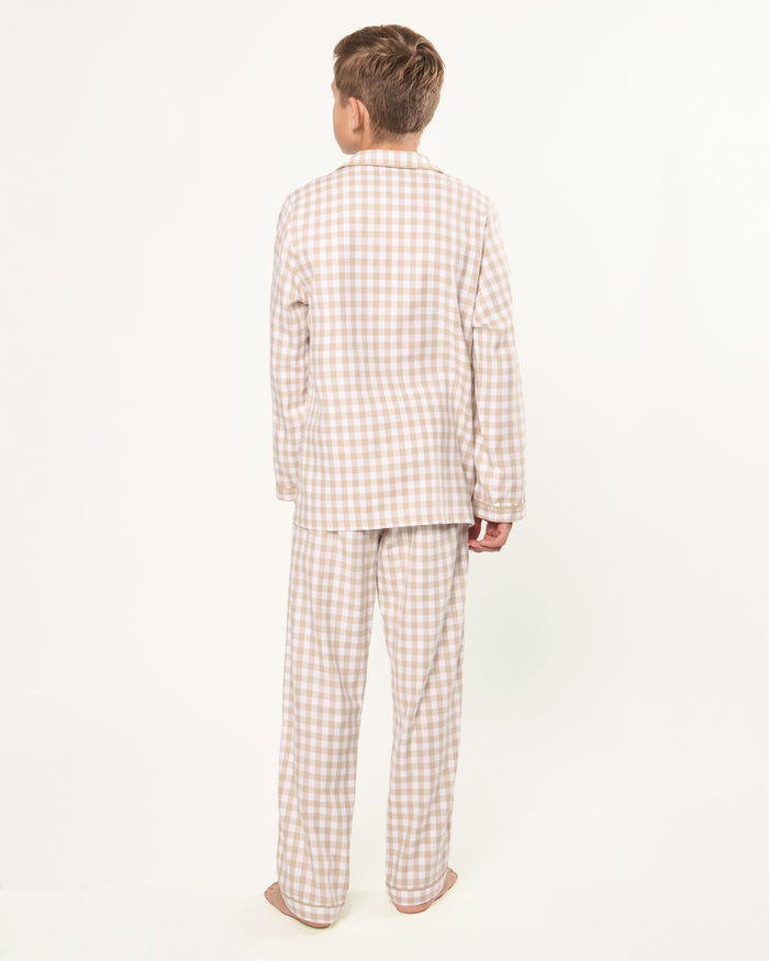 Kid's Twill Pajama Set in Camel Gingham features long sleeves, pants with an elastic waistband, and a button-up shirt with a collar and front pocket, all in a beige and white gingham check pattern.