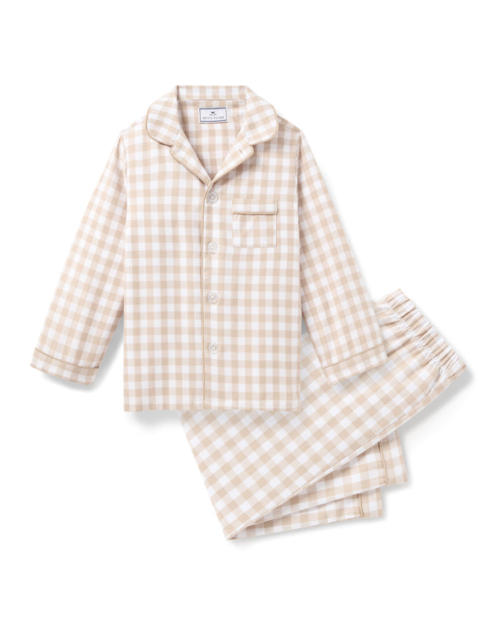 Kid's Twill Pajama Set in Camel Gingham features long sleeves, pants with an elastic waistband, and a button-up shirt with a collar and front pocket, all in a beige and white gingham check pattern.